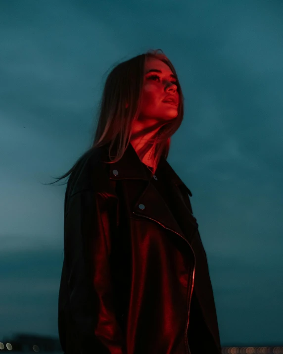 a woman standing in front of the eiffel tower, an album cover, inspired by Elsa Bleda, trending on pexels, aestheticism, black and red jacket, looking menacing, glowing hair, wearing leather