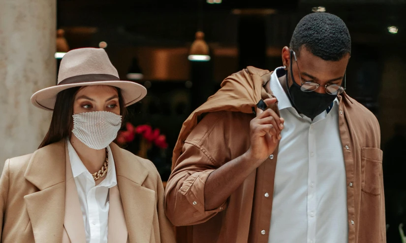 a man and a woman wearing face masks, by Emma Andijewska, trending on pexels, brown clothes, dressed with expensive clothes, promotional image, thumbnail