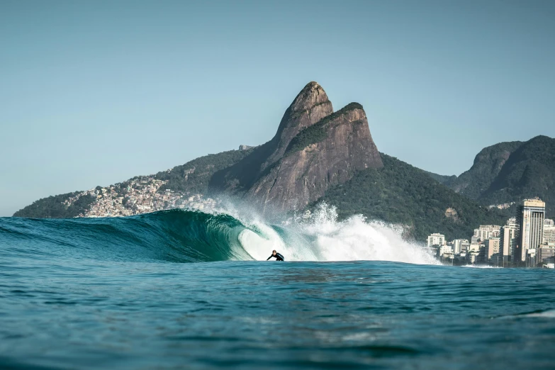 a man riding a wave on top of a surfboard, by Tobias Stimmer, unsplash contest winner, rio de janeiro, hasselblad, beautiful surroundings, slide show