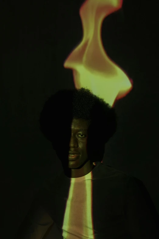 a person standing in front of a fire, an album cover, inspired by Carrie Mae Weems, black man with afro hair, glowing aura, closeup portrait shot, yasuke 5 0 0 px models