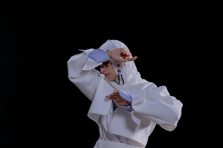 a man in a white robe holding a tennis racquet, an album cover, inspired by Kanō Naizen, unsplash, neo-dada, dynamic dancing pose, die antwoord style wear, holly herndon origami statue, taken with canon 5d mk4