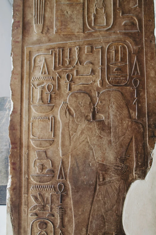 a carving of an elephant on display in a museum, egyptian art, flickr, graffiti, kissing, medium shot of two characters, hieroglyphs on wall, couple