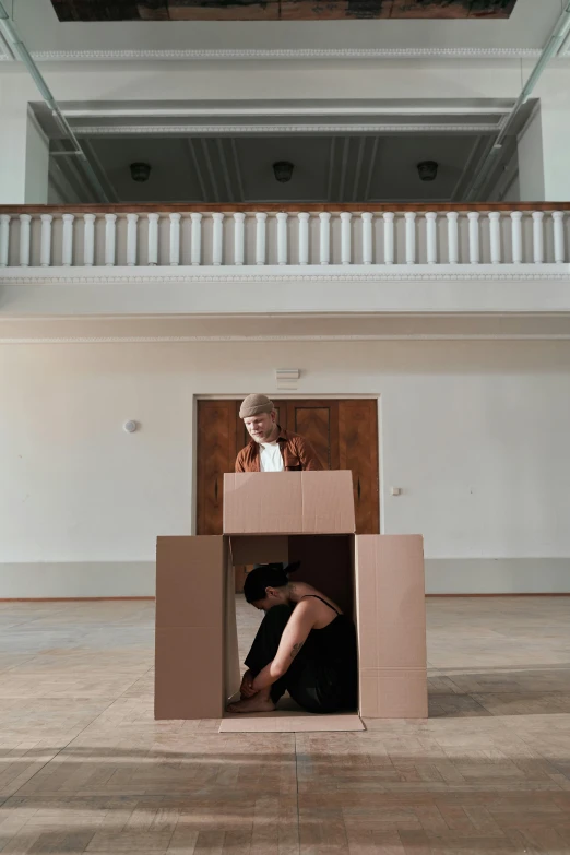 a couple of people that are inside of a box, inspired by Anna Füssli, unsplash, conceptual art, performance, brown, solo, scholarly