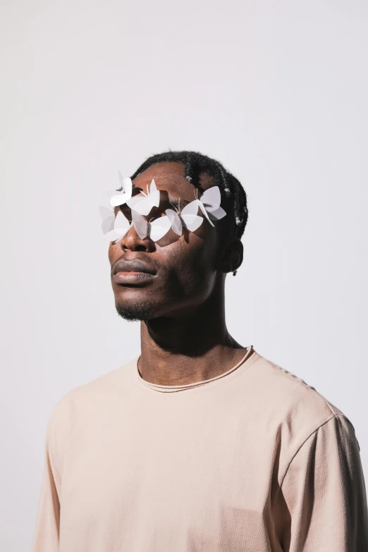 a man with broken glasses on his face, an album cover, inspired by Barthélemy Menn, trending on pexels, butterflies, off - white collection, loosely cropped, halfbody portrait