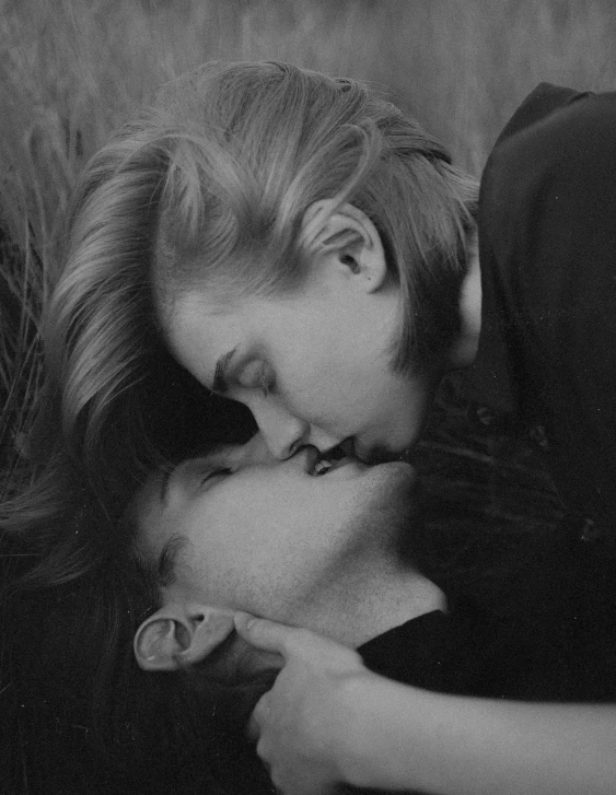 a couple laying on top of each other in a field, a black and white photo, tumblr, romanticism, female link and malon kissing, androgynous person, profile image, pavel tchelitchew