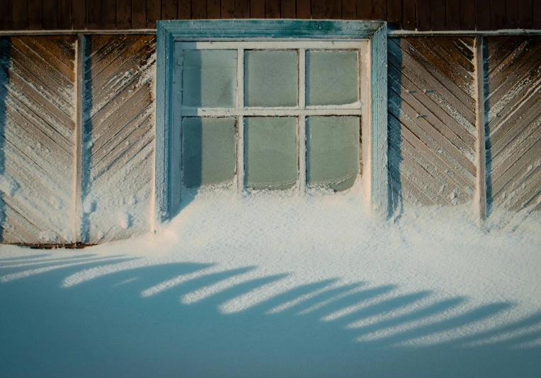 a red fire hydrant sitting in the snow next to a building, inspired by Elsa Bleda, pexels contest winner, fantastic realism, cold sunshine through window, lapland, winter blue drapery, long cast shadows