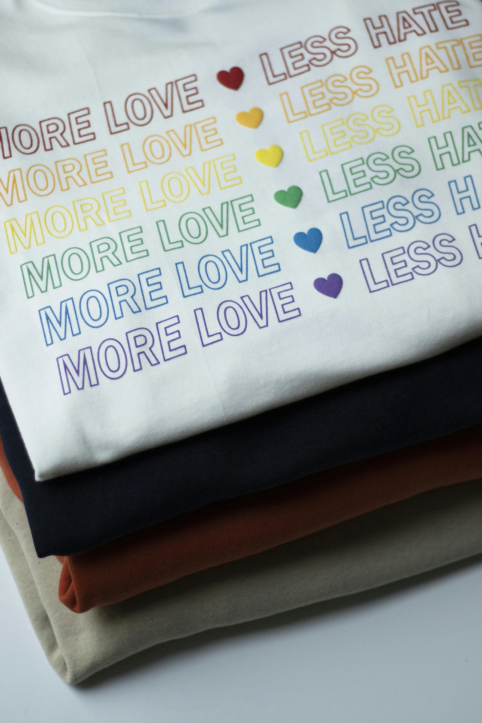 a t - shirt that says more love less hate more love less hate more love less hate more love less hate more love less hate more love, by Mardi Barrie, unsplash, detail shots, muted rainbow tubing, screen printed, moderate colors