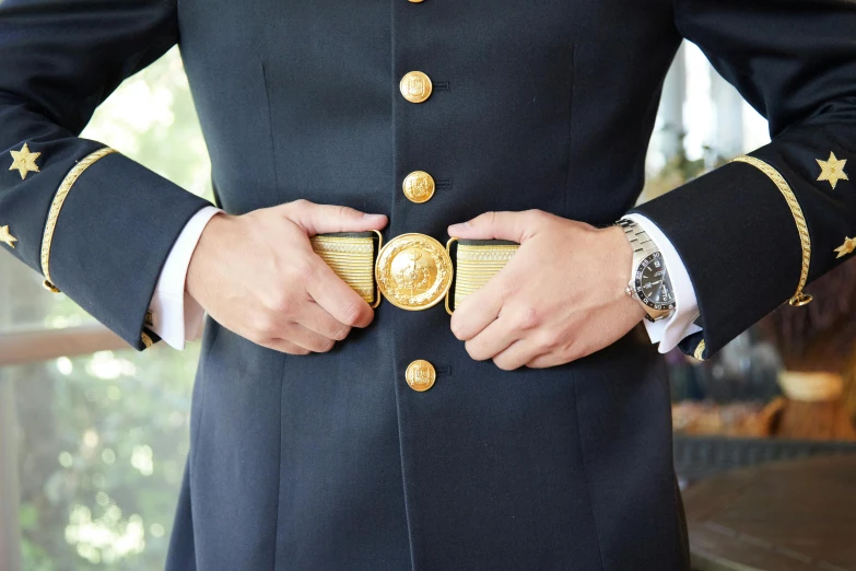 a close up of a person wearing a military uniform, inspired by Horatio Nelson Poole, unsplash, private press, gold belt, subject detail: wearing a suit, magic belt, with an intricate