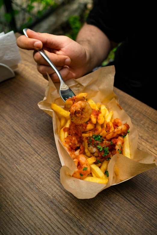 a person sitting at a table with a plate of food, inspired by Pia Fries, pexels contest winner, photorealism, fireball hand, square, krakens, closeup at the food