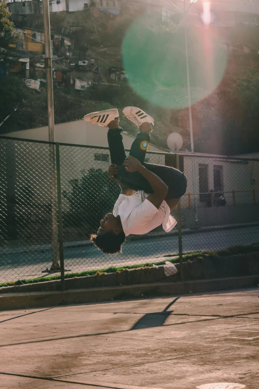 a man flying through the air while riding a skateboard, pexels contest winner, happening, black teenage boy, hanging upside down, laying on the ground, warm light