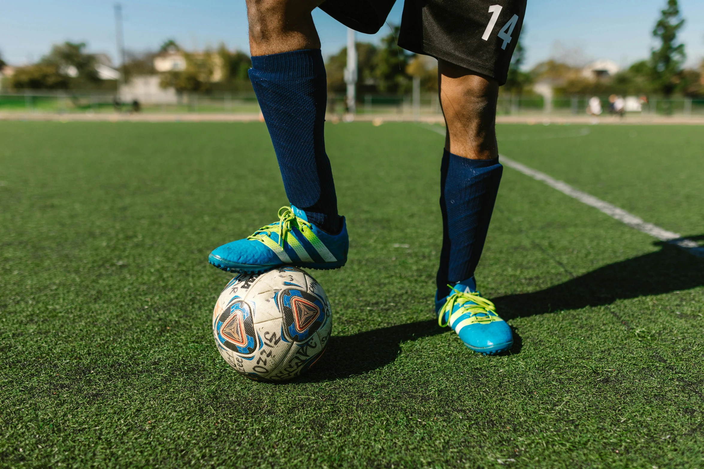 a person kicking a soccer ball on a field, educational, heavy-duty boots, 15081959 21121991 01012000 4k, portrait photo