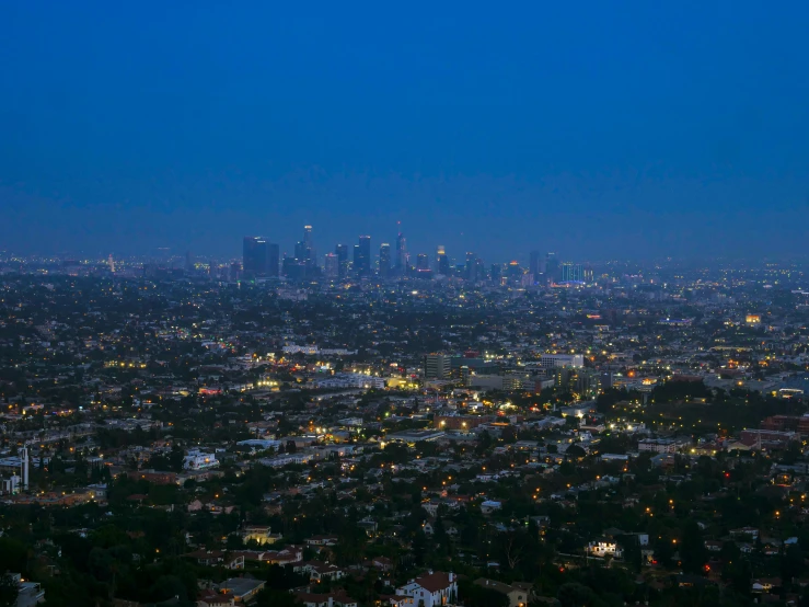 a view of a city at night from the top of a hill, an album cover, inspired by L. A. Ring, unsplash contest winner, renaissance, ☁🌪🌙👩🏾, blue hour photography, late summer evening, hollywood