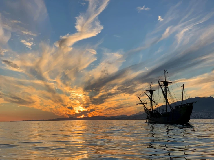 a boat floating on top of a body of water, by Joseph Severn, pexels contest winner, romanticism, pirate ships, during sunset, bay area, thumbnail