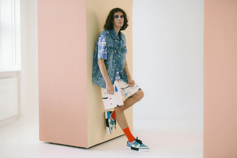 a man leaning against a wall with a skateboard, by Carey Morris, off - white collection, wearing shorts, mixed styles, vapourwave