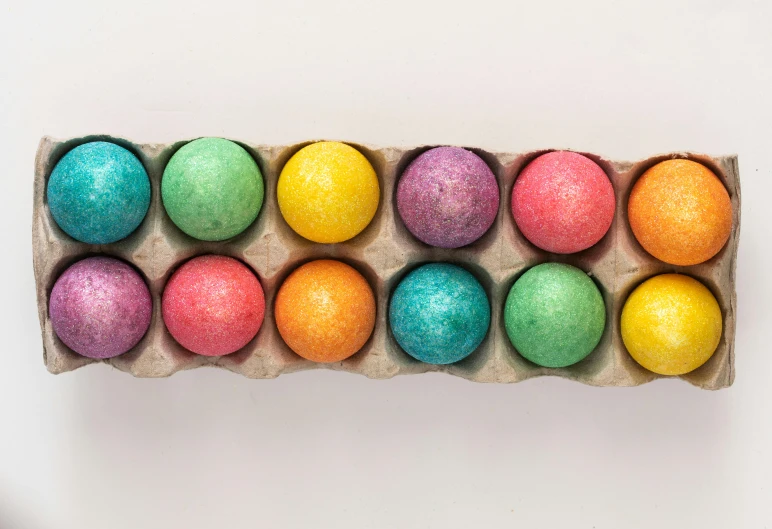 a carton filled with colorful easter eggs, a pastel, by Joe Bowler, pexels, bottom - view, dezeen, essence, up-close