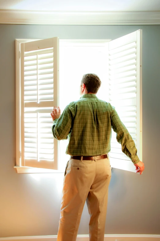 a man standing in front of an open window, shutters, comforting, bay area, leaving a room