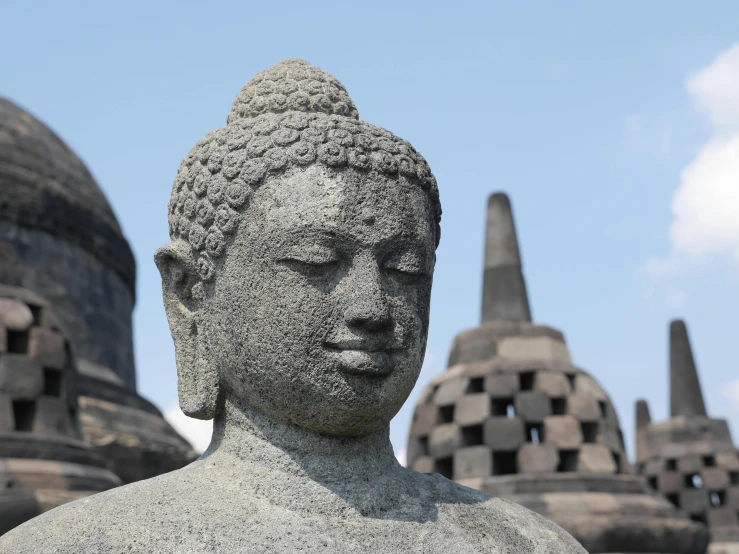 a close up of a statue in front of a building, pexels contest winner, sumatraism, at borobudur, grey, avatar image, thumbnail