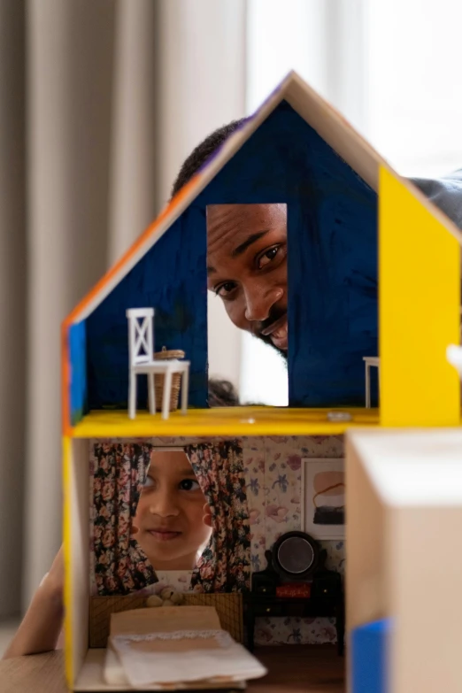 a man and a little girl playing with a doll house, by Arabella Rankin, pexels contest winner, photorealism, closeup of face, aida muluneh, helio oiticica, built on a small