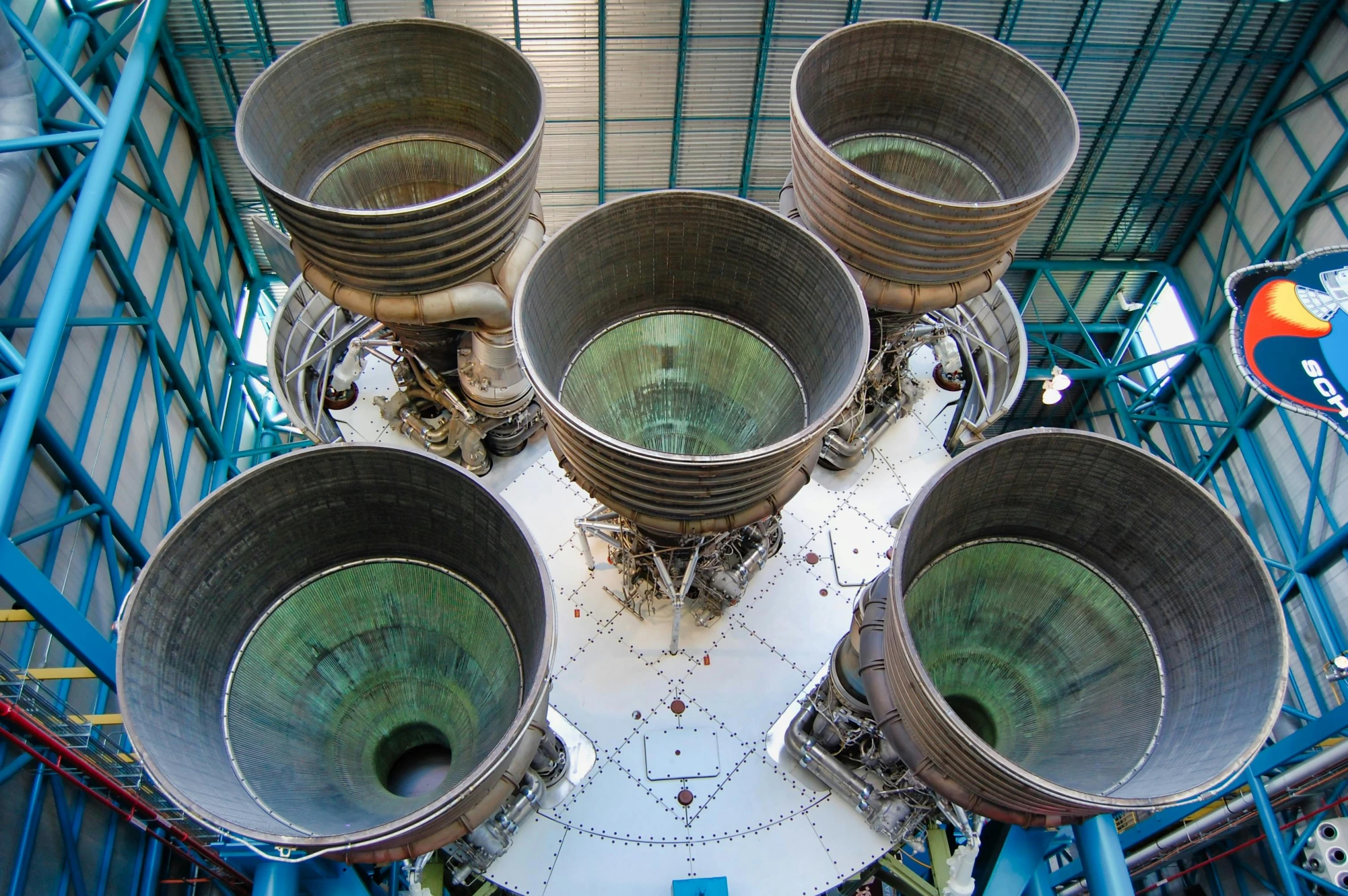 a group of metal buckets sitting inside of a building, saturn v, large blue engines, 🦩🪐🐞👩🏻🦳, taken in the late 2010s