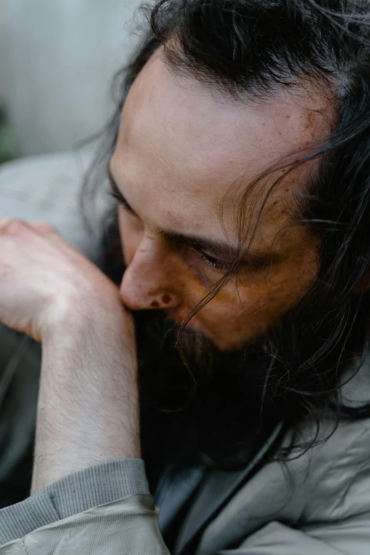 a man sitting in front of a laptop computer, by artist, unsplash, messy long black hair, head bowed slightly, homeless, sideburns