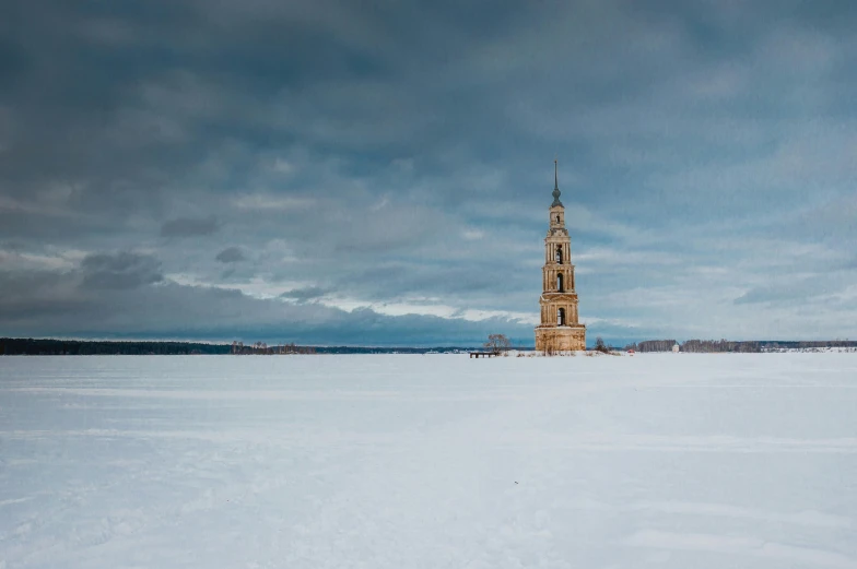 a clock tower sitting on top of a snow covered field, by Ilya Ostroukhov, pexels contest winner, in the middle of a lake, plain background, saint petersburg, 2022 photograph