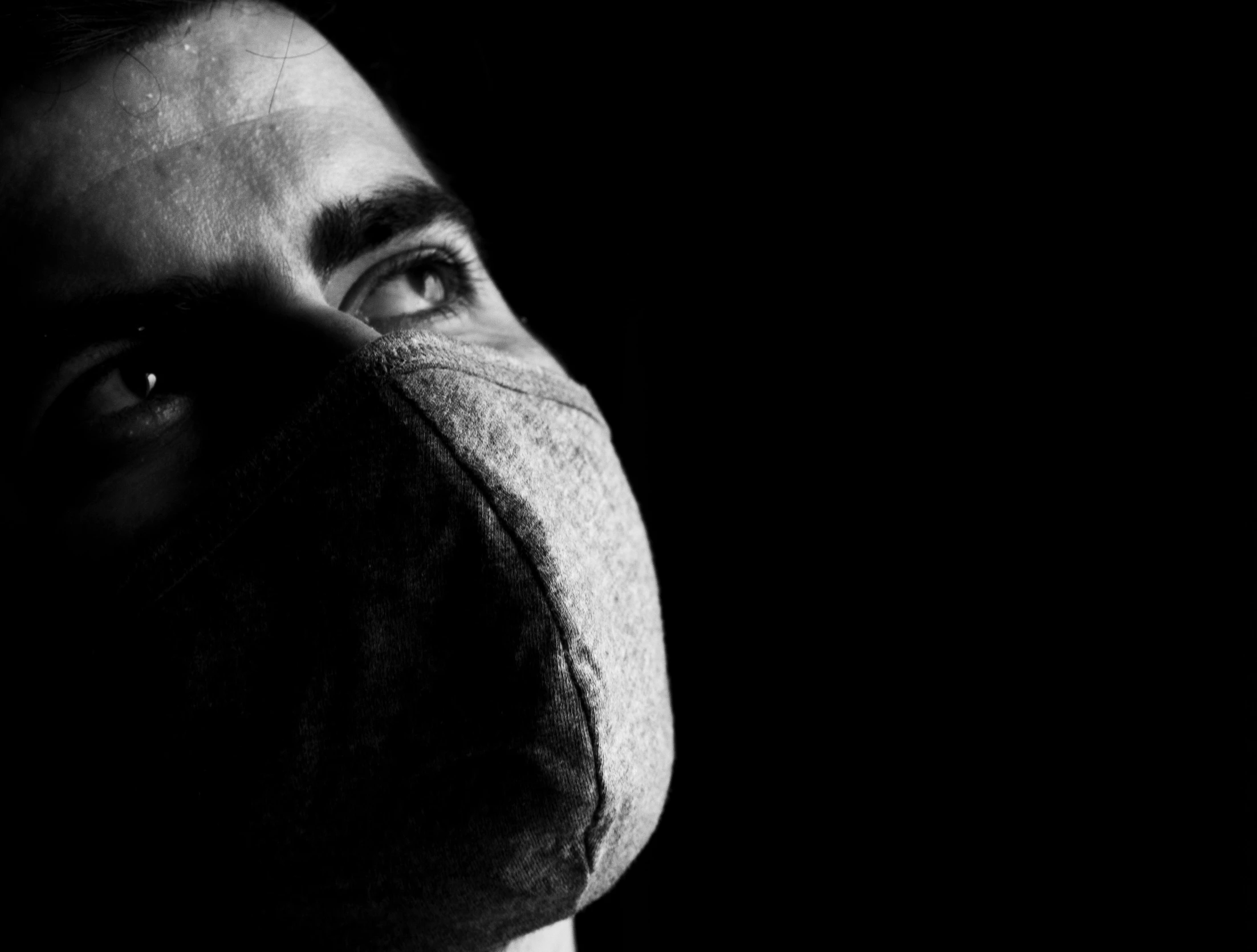 a black and white photo of a man wearing a mask, a black and white photo, inspired by Nicola Samori, pexels, fabric, kafka, nose, surgeon