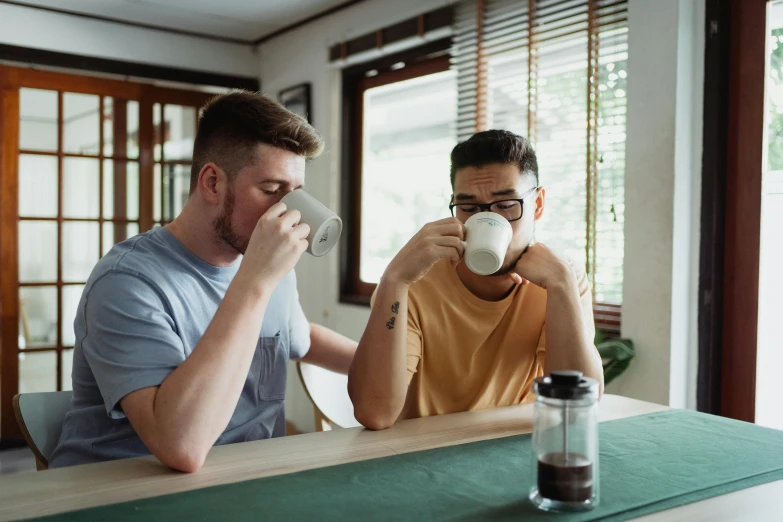 two men sitting at a table drinking coffee, pexels contest winner, avatar image, lgbt, australian, 1 2 9 7