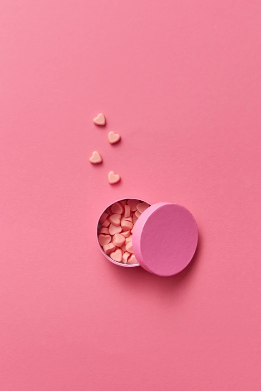 a pink container filled with hearts on top of a pink surface, by Jakob Emanuel Handmann, pexels, pills, ((pink)), clemens ascher, 15081959 21121991 01012000 4k