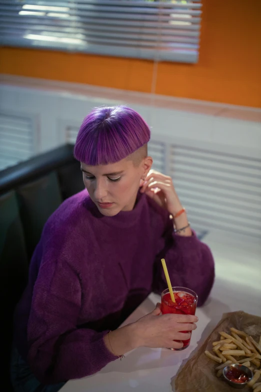 a woman with purple hair sitting at a table, inspired by Ruth Deckard, trending on pexels, purism, brown buzzcut, standing in a starbase bar, snacks, kirsi salonen