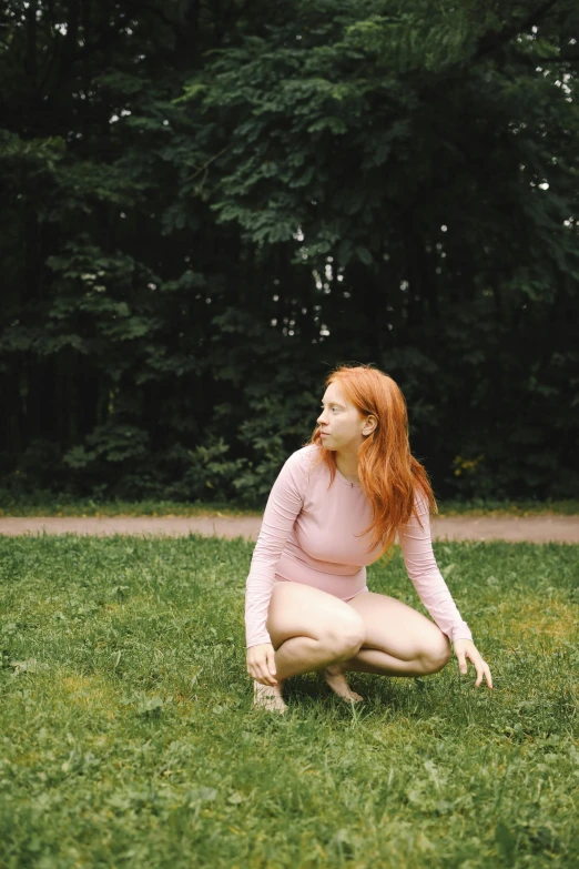 a woman kneeling in the grass with a frisbee, an album cover, inspired by Elsa Bleda, pexels contest winner, renaissance, ginger hair, pink body, extremely pale, looking outside