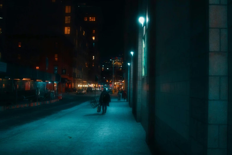 a person riding a bike down a street at night, a picture, inspired by Elsa Bleda, unsplash contest winner, realism, dark teal lighting, new york back street, people walking down a street, perfectly lit. movie still