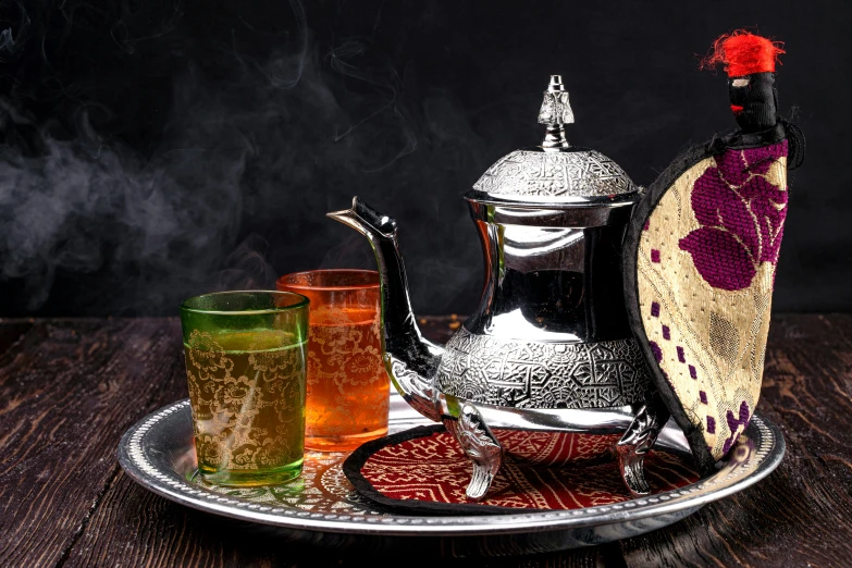 a silver tea pot sitting on top of a silver tray, an album cover, inspired by Osman Hamdi Bey, hurufiyya, drinks, thumbnail, rustic, mangeta smoke red light