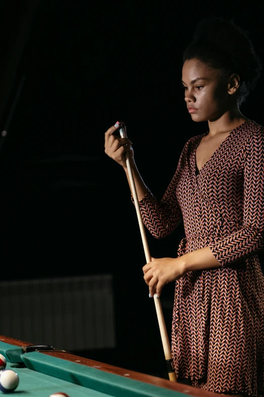 a woman standing next to a pool table holding a cue, unsplash, visual art, wearing an african dress, ( ( theatrical ) ), performance, digital image