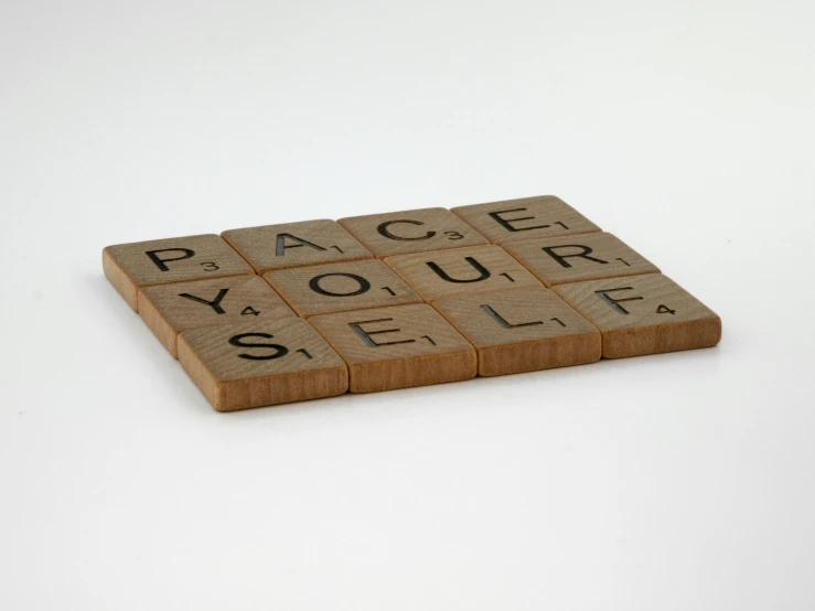 a scrabble board with the words race your self written on it, by Roger Cecil, dau-al-set, laser cut, peaceful, - 12p, front facing shot
