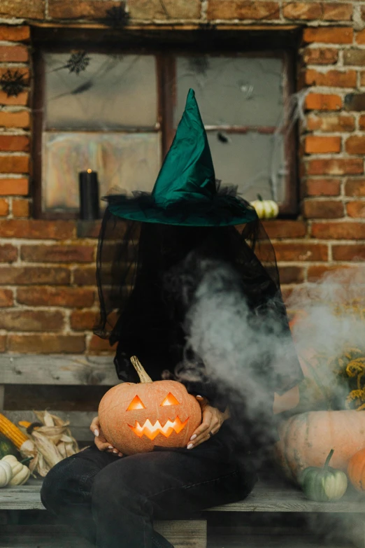 a person in a witch's hat sitting on a bench with pumpkins and gourds, pexels contest winner, whirling smoke, dry ice, gif, profile image