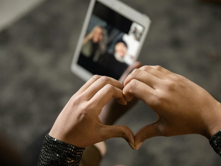 a person making a heart with their hands, trending on pexels, video art, using a magical tablet, shot with sony alpha, in love selfie, rectangle