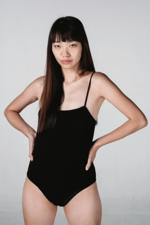 a woman in a black swimsuit posing for a picture, inspired by Feng Zhu, wearing : tanktop, 2 0 yo, minimal clothing, 奈良美智