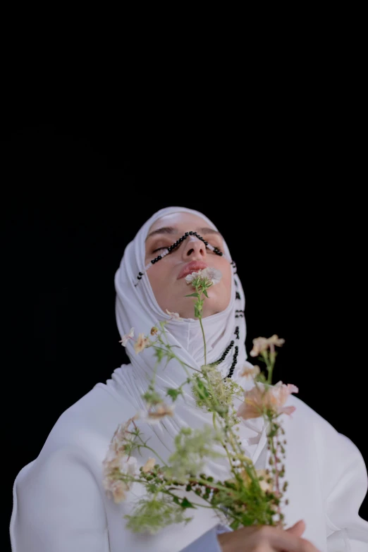 a woman dressed in white holding a bunch of flowers, an album cover, inspired by Maryam Hashemi, hurufiyya, still from a music video, hijab, charli xcx, taken with sony alpha 9