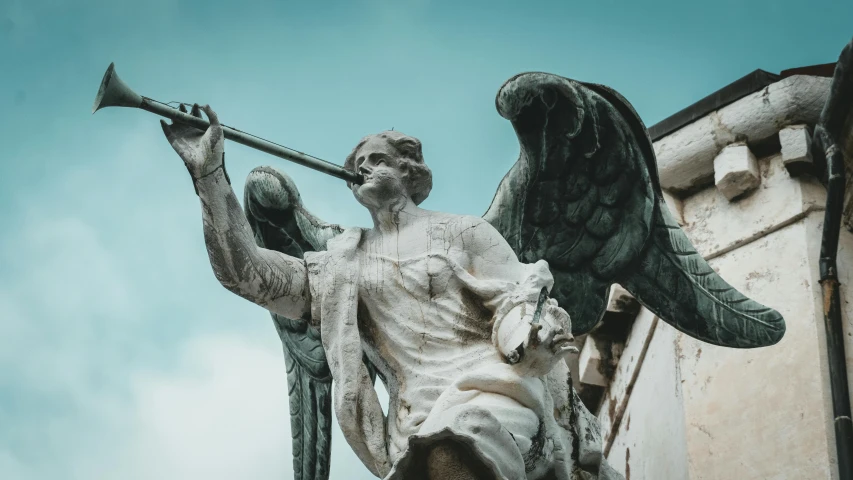 a statue of an angel holding a trumpet, a statue, by Daniel Lieske, pexels contest winner, sword pointed at sky, painted marble sculptures, discovered photo, silver wings