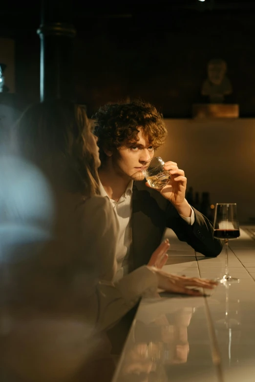 a man and a woman sitting at a bar, by Daniel Seghers, pexels contest winner, renaissance, joe keery, holding a glass of wine, pondering, curly haired