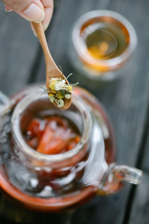 a person holding a wooden spoon over a tea pot, pexels, hurufiyya, ice tea in a mason jar, poppy, thumbnail, dwell