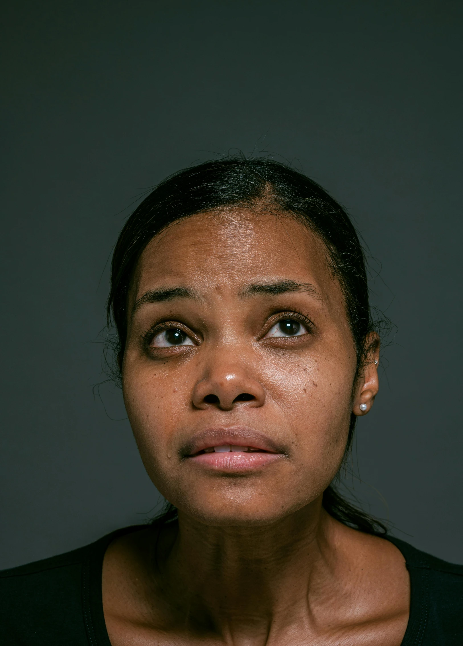 a close up of a person wearing a black shirt, by Christopher Williams, police lights shine on her face, mugshot, qiyana, ap news photograph