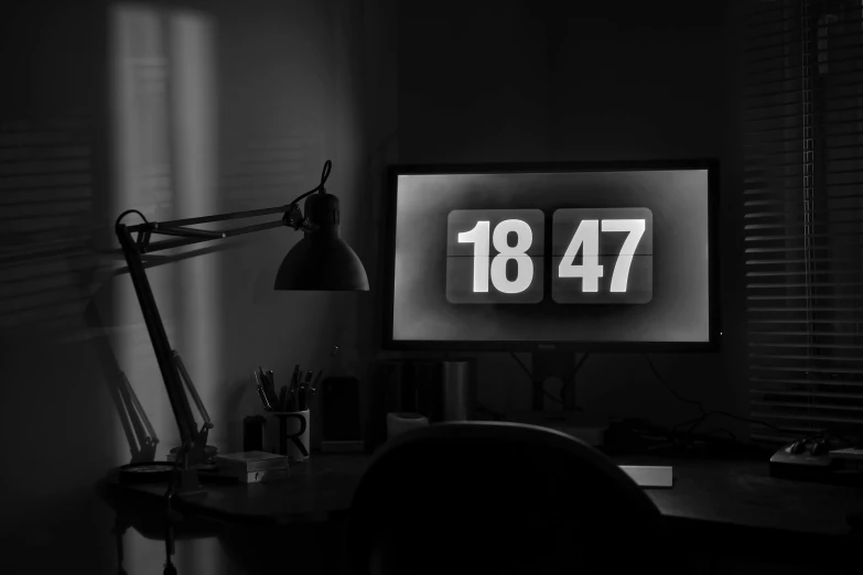 a black and white photo of a desk with a clock on it, by Adam Marczyński, plasma display, year 2447, thumbnail, pc screen image