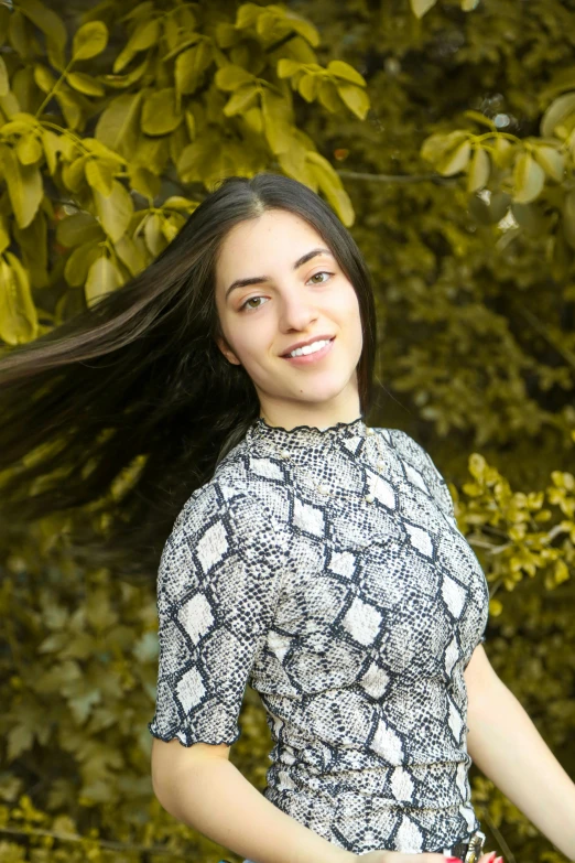 a woman that is standing in the grass with a frisbee, long swirly dark hair, headshot photoshoot, asher duran, 19-year-old girl