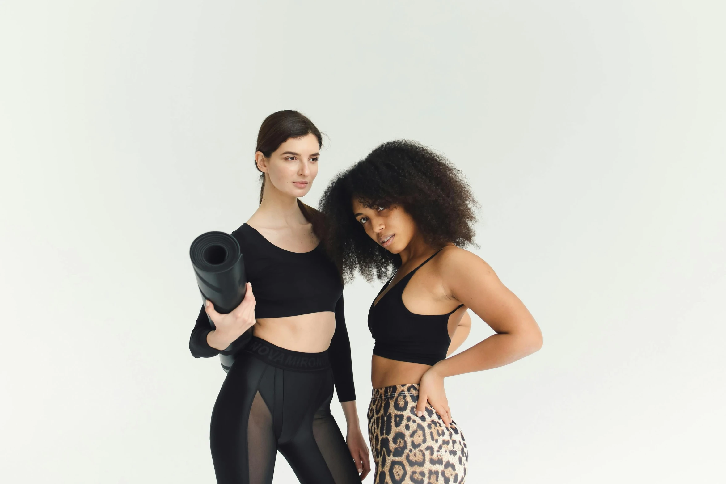 a couple of women standing next to each other, trending on pexels, renaissance, black spandex, product introduction photo, mixed styles, wearing crop top