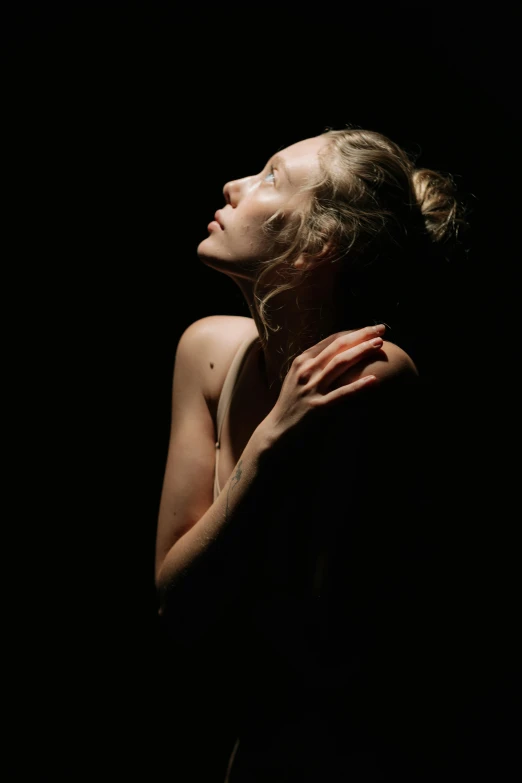 a woman that is standing in the dark, an album cover, unsplash, renaissance, ryan mcginley, sydney sweeney, sunbathed skin, hands in her hair. side-view