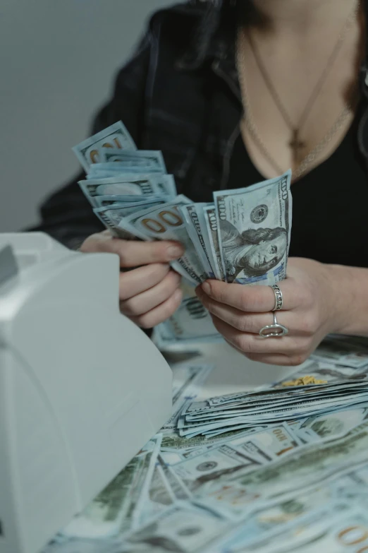 a woman counting money at a cash register, pexels contest winner, renaissance, 🚀🌈🤩, wētā fx, on a white table, dollar bills body horror