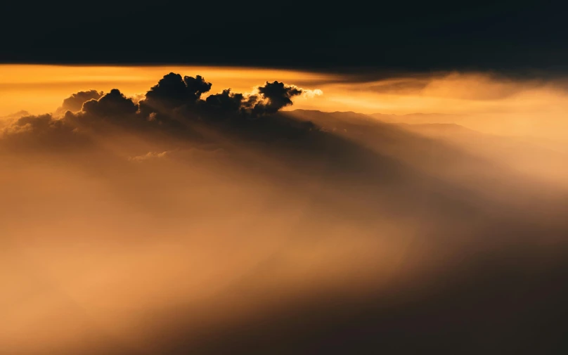 a plane flying through a cloud covered sky, by Sebastian Spreng, pexels contest winner, romanticism, orange mist, evening lighting, gold ethereal light, landscape photo