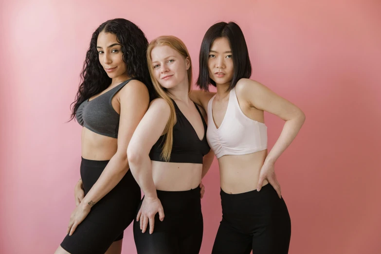 a group of three women standing next to each other, pexels contest winner, sports bra, avatar image, asian descent, pink and black