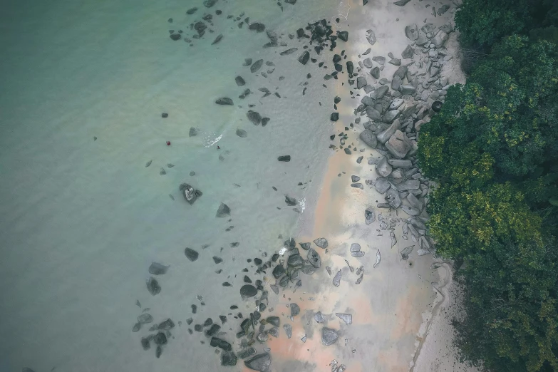 an aerial view of a beach with rocks and water, faded colors, floating away, stingrays, instagram photo